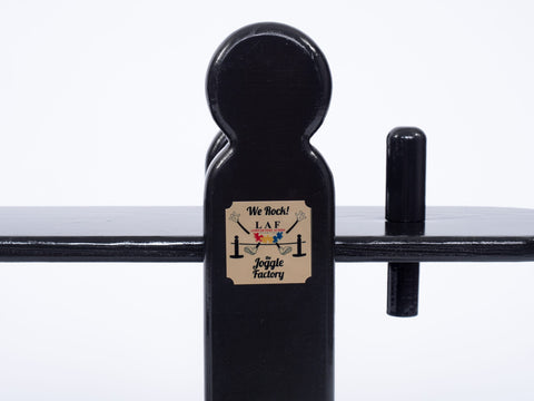 Close up picture of a Charleston green joggling board rocker, showing the brass plaque of the joggling board.
