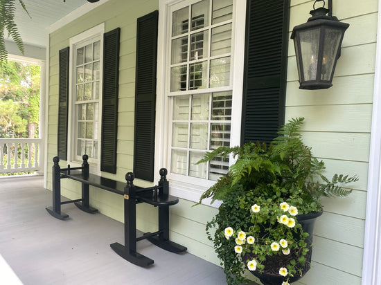 6' Charleston green joggling board on front porch with large shutters and windows, built by The Joggle Factory.