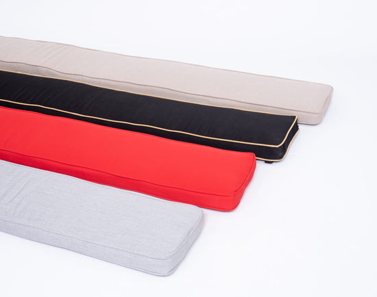 4 joggling board cushions in grey, black, red and tan on white background.