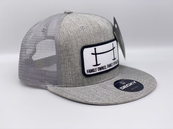 The Joggle Factory grey trucker hat with Family Owned Family Operated on the patch.