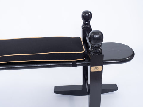 Top view of black and gold cushion on a Charleston green Joggling board. 
